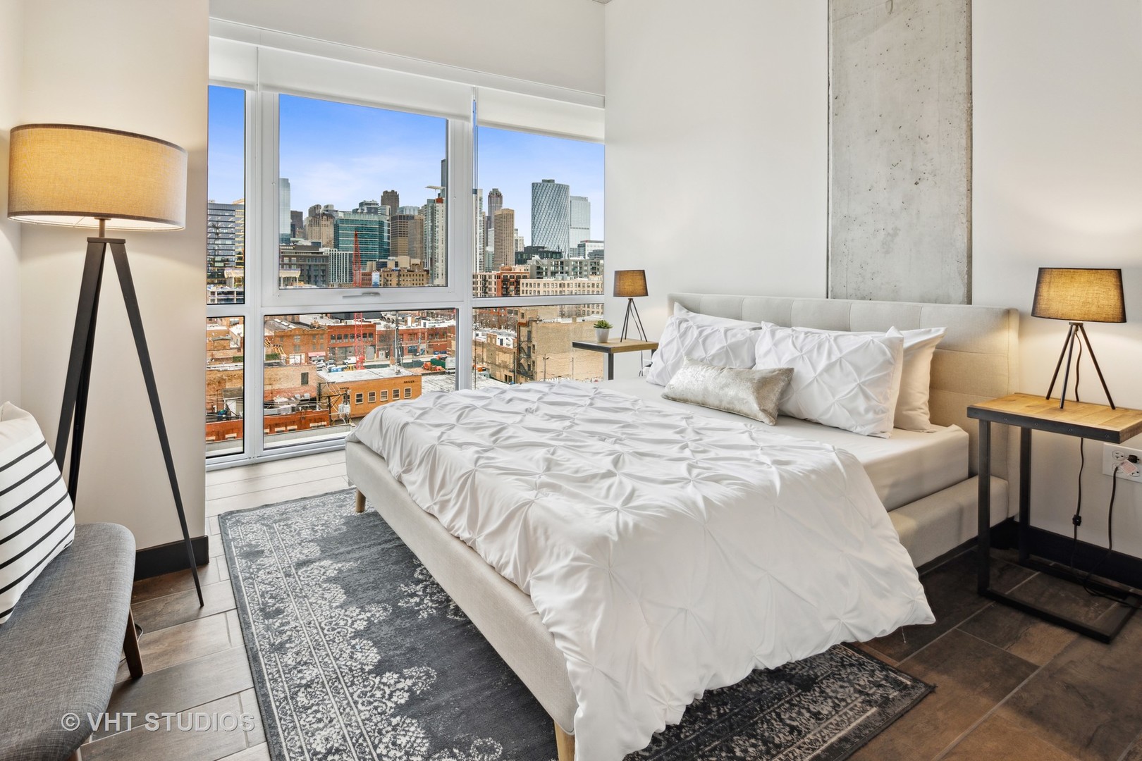 171 North Aberdeen Street, Unit 806 Chicago, IL 60607 - Photo 10 of 18 a large bedroom with a bed and wooden floor