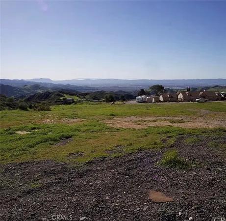 a view of a big yard with wooden floor and a houses