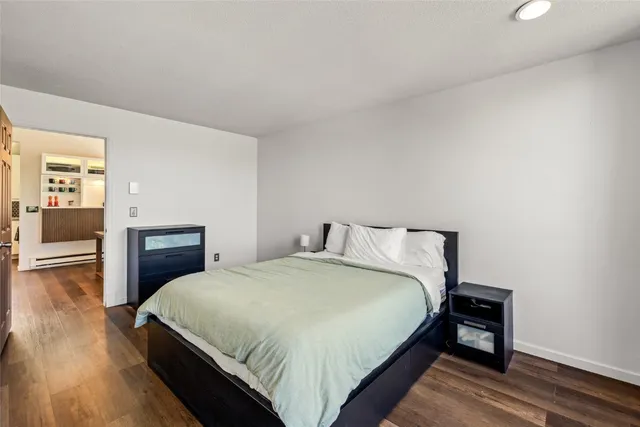 a large bed sitting in a bedroom and a table