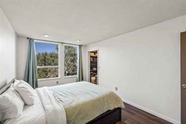 a bed sitting in a bedroom next to a window