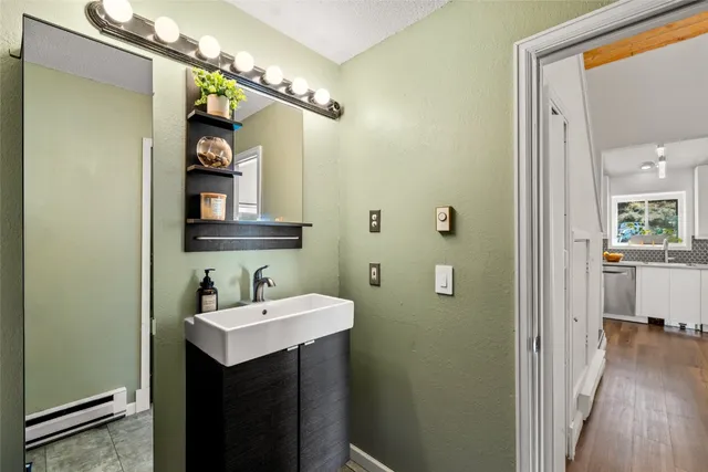 a bathroom with a sink and mirror