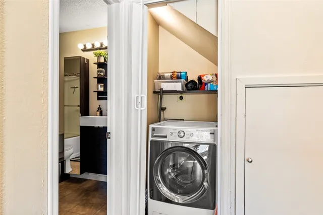 a view of washer and dryer with a kitchen view