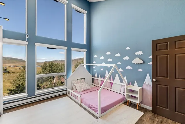 a spacious bedroom with a bed and window