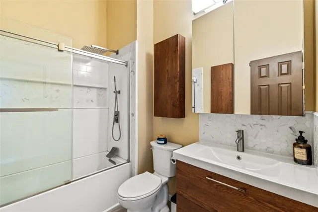 a bathroom with a toilet sink and shower