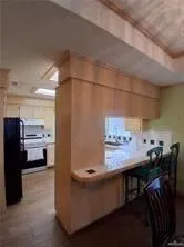 a kitchen with a refrigerator stove and white cabinets