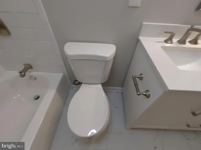 a bathroom with a toilet and a sink