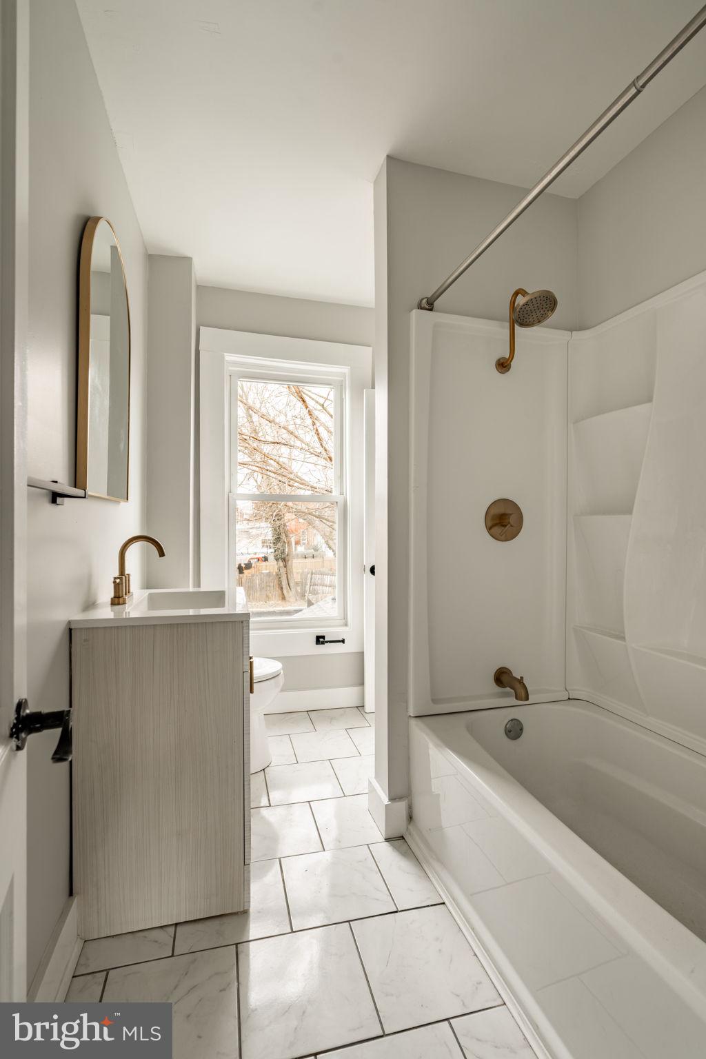 471 High Street Lancaster, PA 17603 - Photo 16 of 22 a bathroom with a tub a sink a mirror and a shower