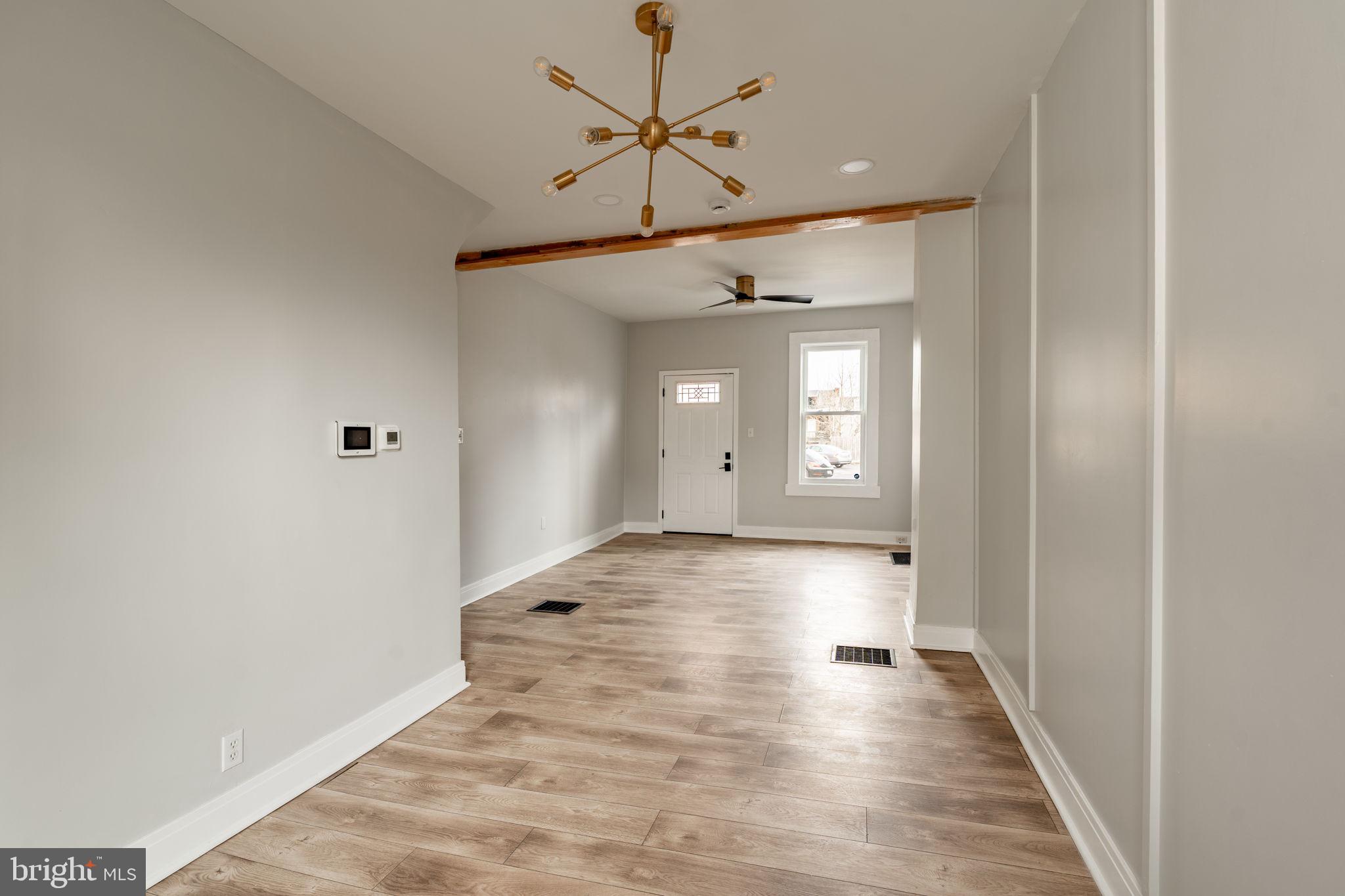 471 High Street Lancaster, PA 17603 - Photo 4 of 22 a view of a hallway with wooden floor and a chandelier fan