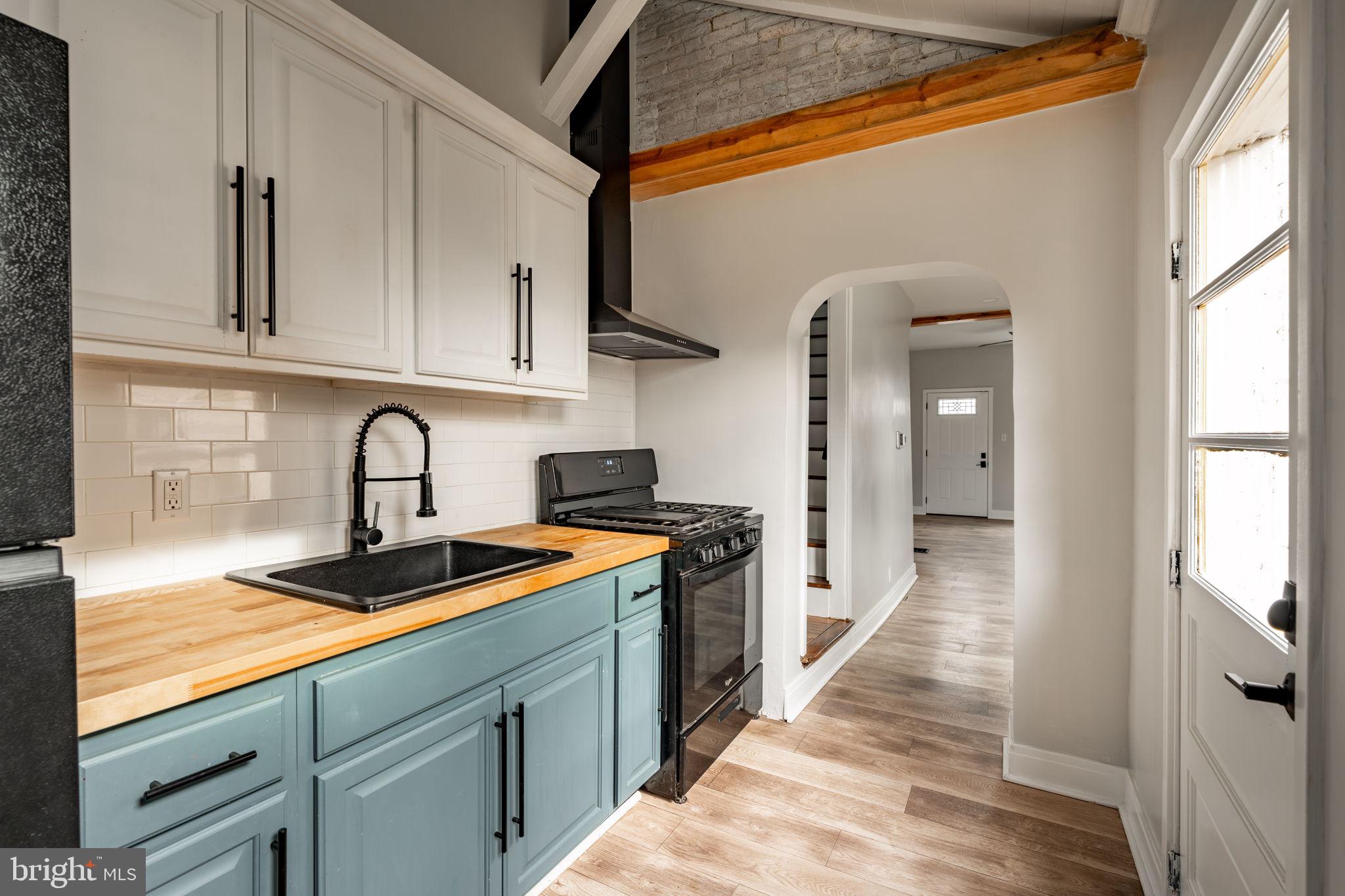 471 High Street Lancaster, PA 17603 - Photo 9 of 22 a kitchen with stainless steel appliances granite countertop a sink and cabinets with wooden floor