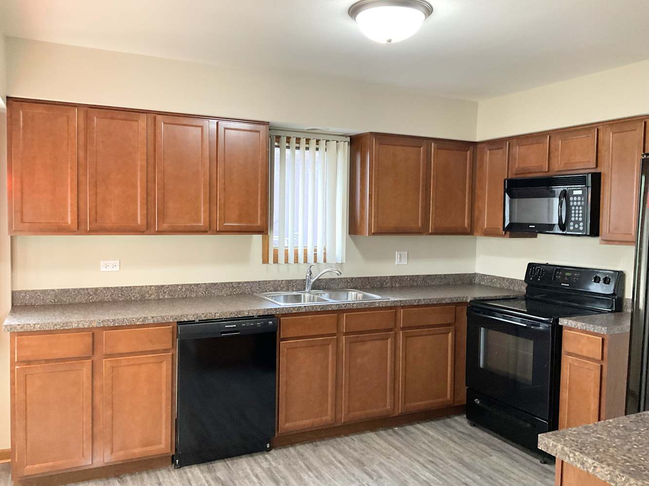 15515 Long Avenue Oak Forest, IL 60452 - Photo 2 of 10 a kitchen with granite countertop stainless steel appliances a sink dishwasher and wooden cabinets with wooden floor