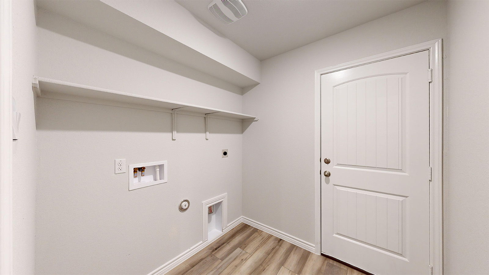 700 Gauge Road Thorndale, TX 76577 - Photo 21 of 22 Laundry room with hookup for a gas dryer, washer hookup, light wood-style floors, and hookup for an electric dryer