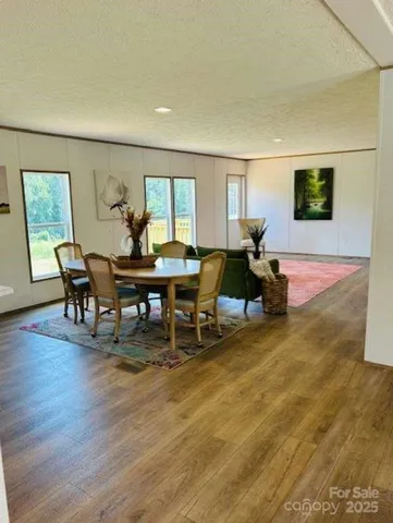 a view of a livingroom with furniture window and wooden floor