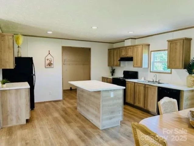 a kitchen with a sink a stove and refrigerator