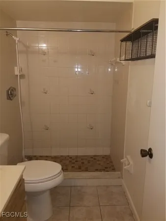 a bathroom with a toilet and shower