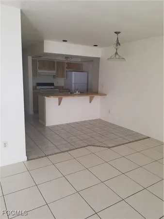 a view of a refrigerator and window in a room