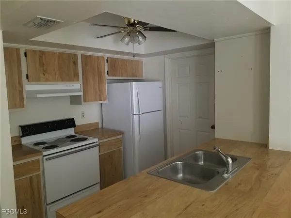 a kitchen with kitchen island a sink appliances and cabinets