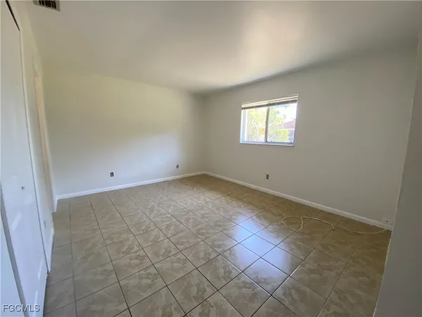 an empty room with white walls and tiles