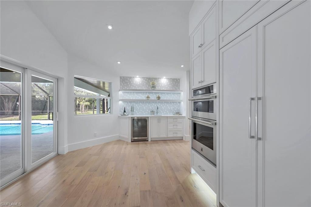 5253 Sycamore Drive Naples, FL 34119 - Photo 13 of 49 a view of kitchen with wooden floor