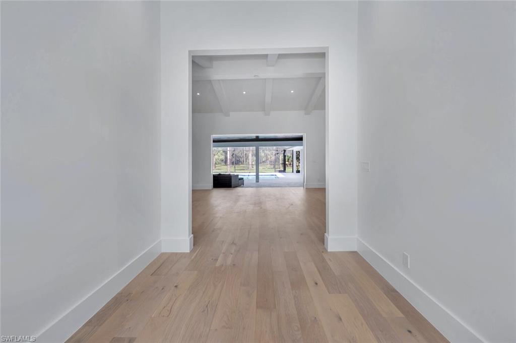 5253 Sycamore Drive Naples, FL 34119 - Photo 16 of 49 a view of a room with wooden floor and a window