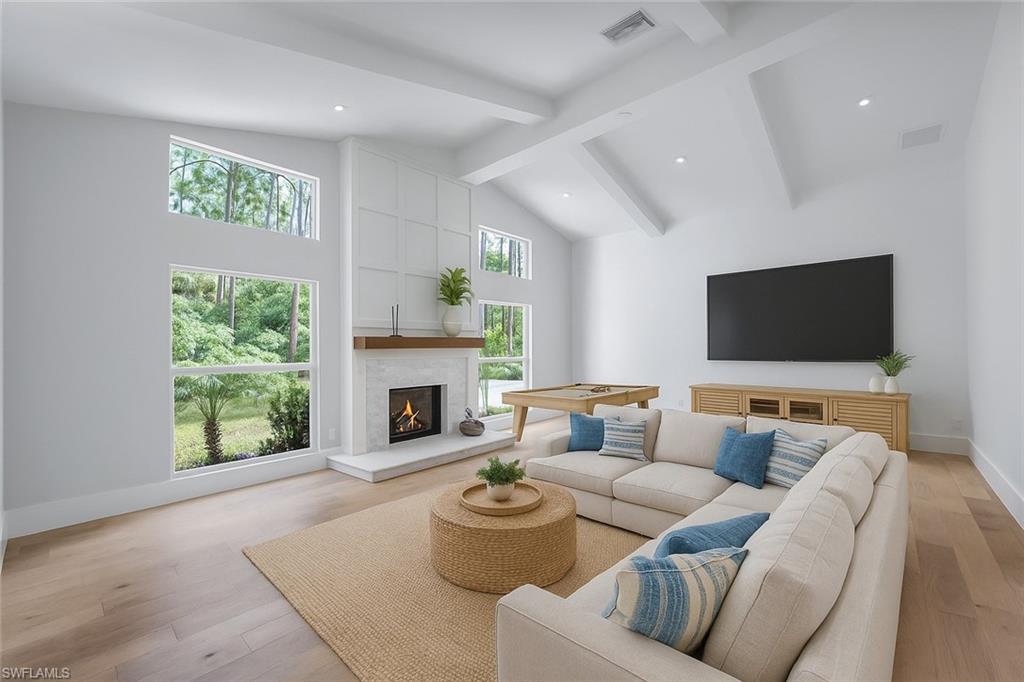 5253 Sycamore Drive Naples, FL 34119 - Photo 18 of 49 a living room with furniture and a fireplace