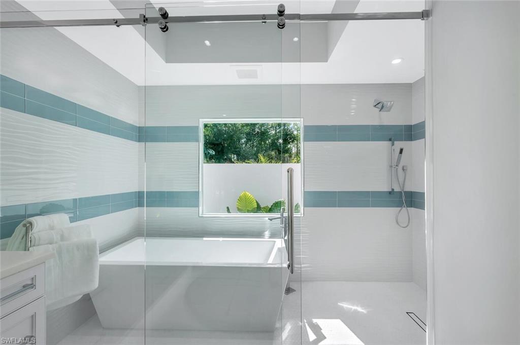 5253 Sycamore Drive Naples, FL 34119 - Photo 23 of 49 a bathroom with a tub and a shower