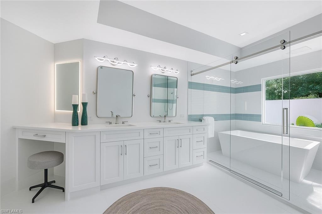 5253 Sycamore Drive Naples, FL 34119 - Photo 24 of 49 a spacious bathroom with a double vanity sink mirror and bathtub