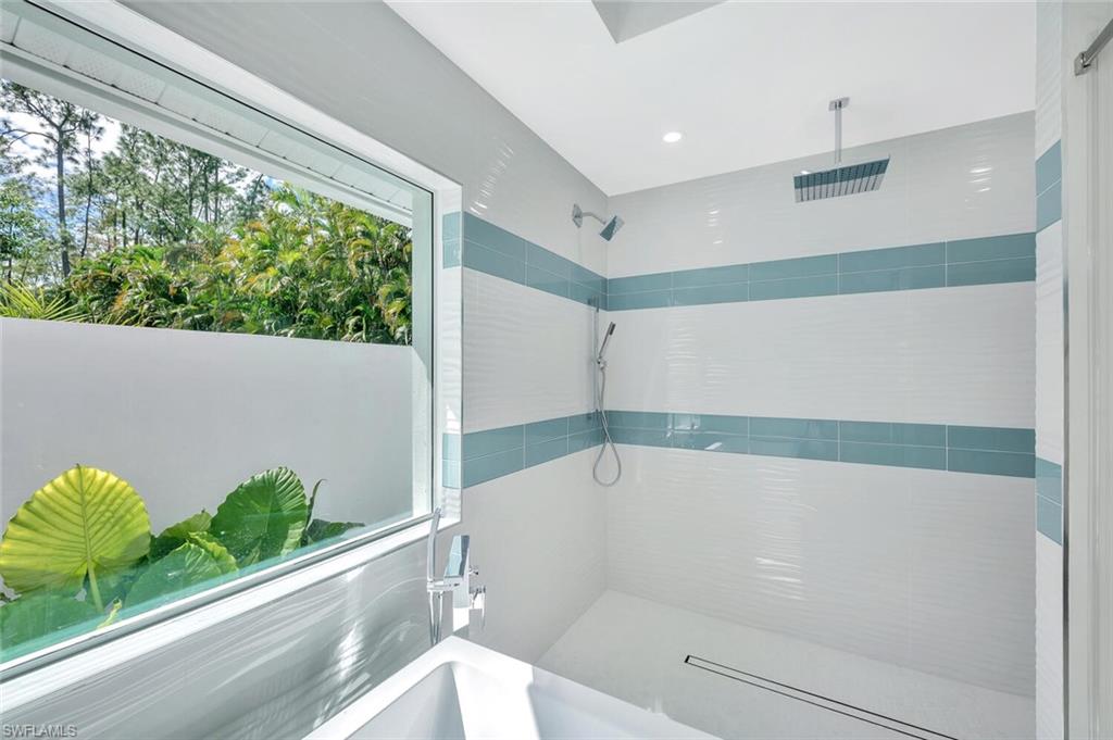 5253 Sycamore Drive Naples, FL 34119 - Photo 25 of 49 a bathroom with a bathtub and a shower