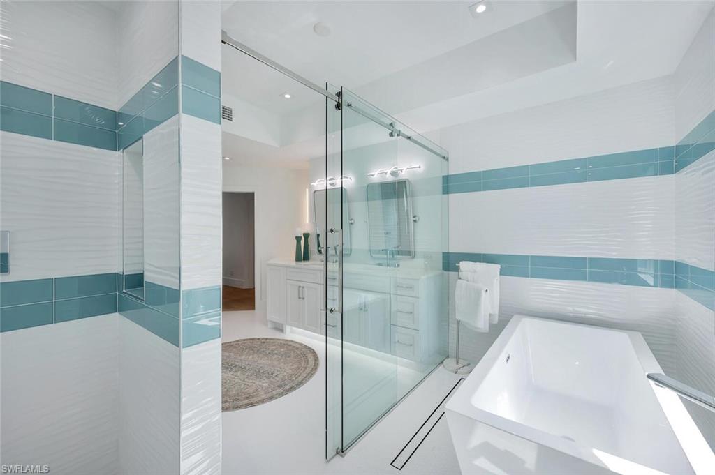 5253 Sycamore Drive Naples, FL 34119 - Photo 26 of 49 a bathroom with a sink and a shower