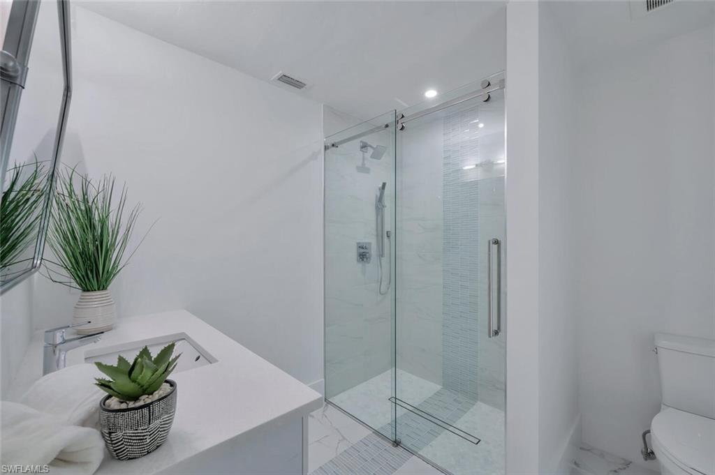 5253 Sycamore Drive Naples, FL 34119 - Photo 31 of 49 a bathroom with a shower a sink and a potted plant