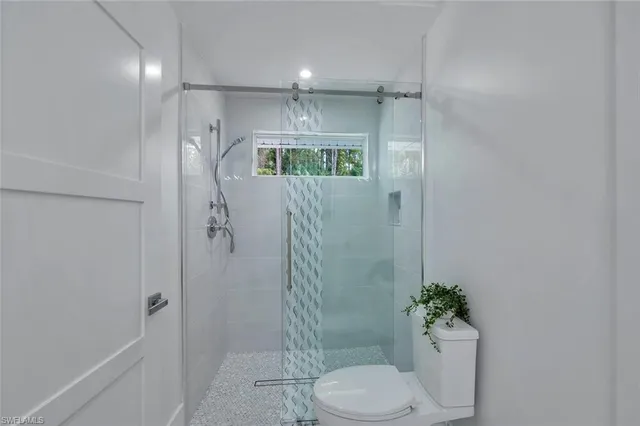 a bathroom with a sink a potted plant and a mirror