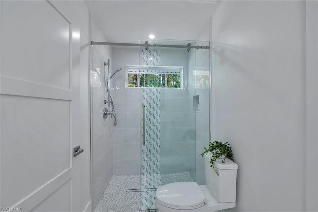 5253 Sycamore Drive Naples, FL 34119 - Photo 34 of 49 a bathroom with a toilet and a shower
