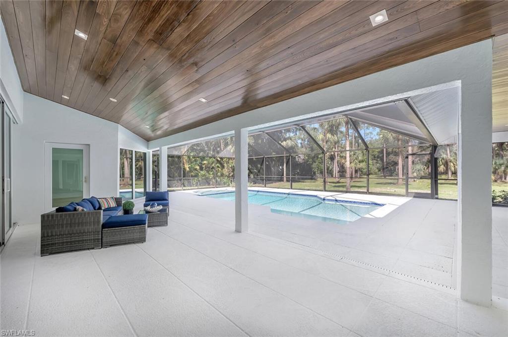5253 Sycamore Drive Naples, FL 34119 - Photo 37 of 49 a living room with furniture and large windows
