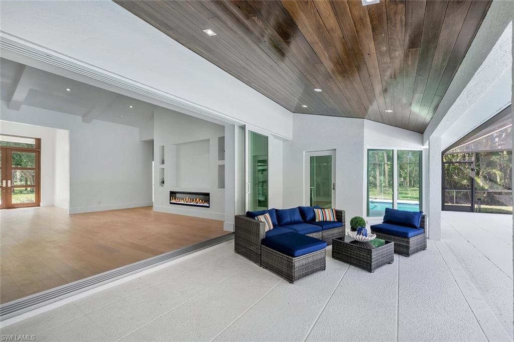 5253 Sycamore Drive Naples, FL 34119 - Photo 38 of 49 a living room with furniture and a large window