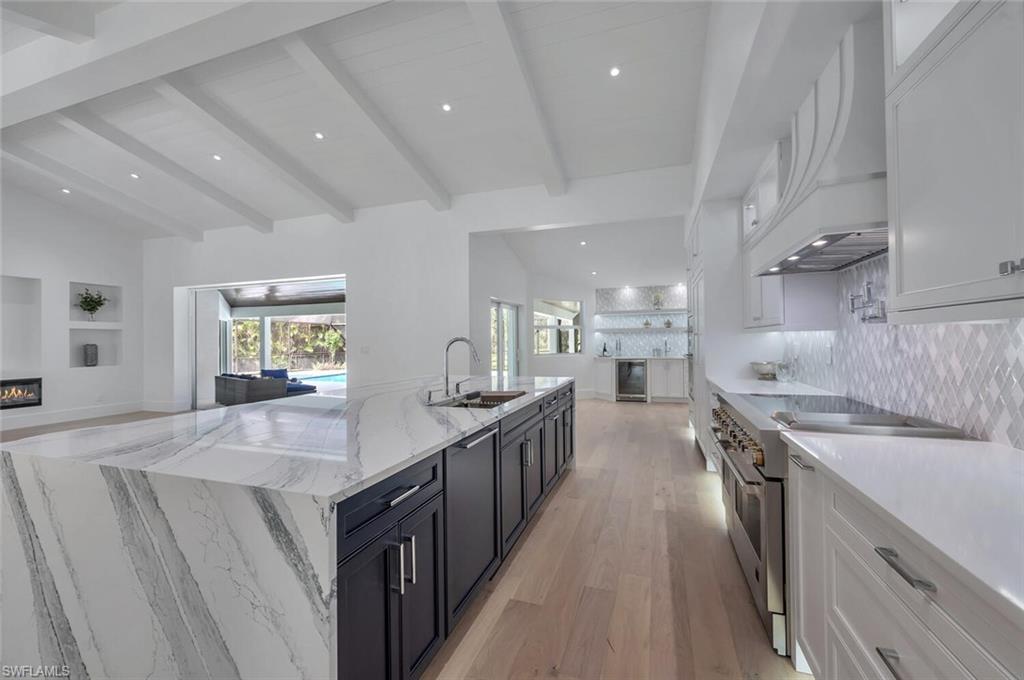 5253 Sycamore Drive Naples, FL 34119 - Photo 4 of 49 a kitchen with counter top space sink stove and refrigerator