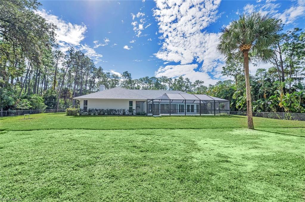 5253 Sycamore Drive Naples, FL 34119 - Photo 45 of 49 a view of a big yard next to a house