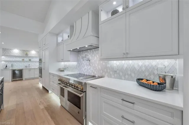 a kitchen with stainless steel appliances white cabinets and a stove