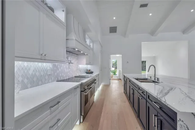 a kitchen with a sink stove and cabinets