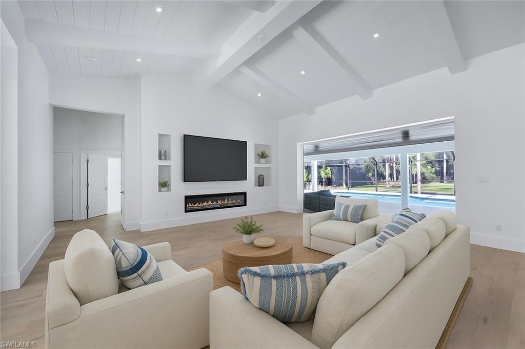 5253 Sycamore Drive Naples, FL 34119 - Photo 9 of 49 a living room with furniture and a flat screen tv