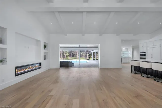 an empty room with wooden floor and furniture