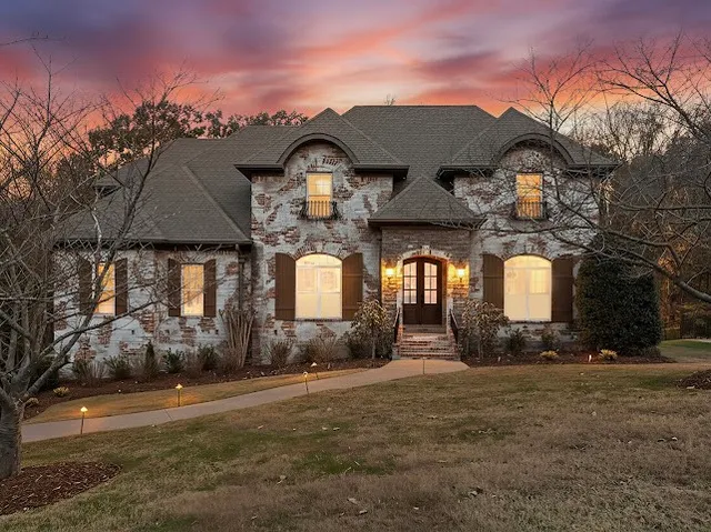 a front view of a house with a yard