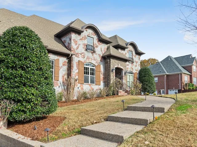 a view of a livingroom with wooden floor a fireplace and entryway
