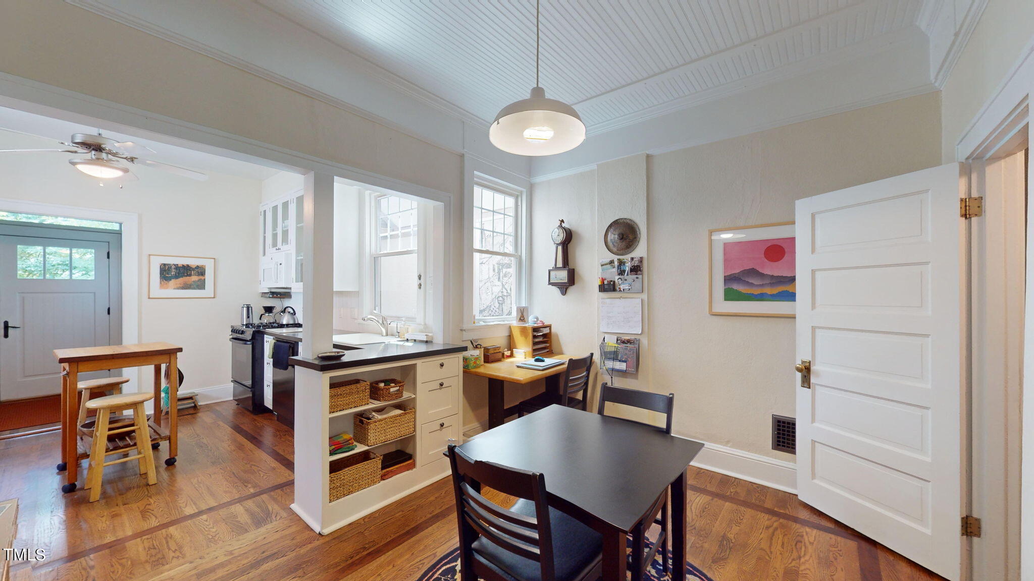132 Woodburn Road Raleigh, NC 27605 - Photo 16 of 53 a view of a dining room with furniture window and wooden floor