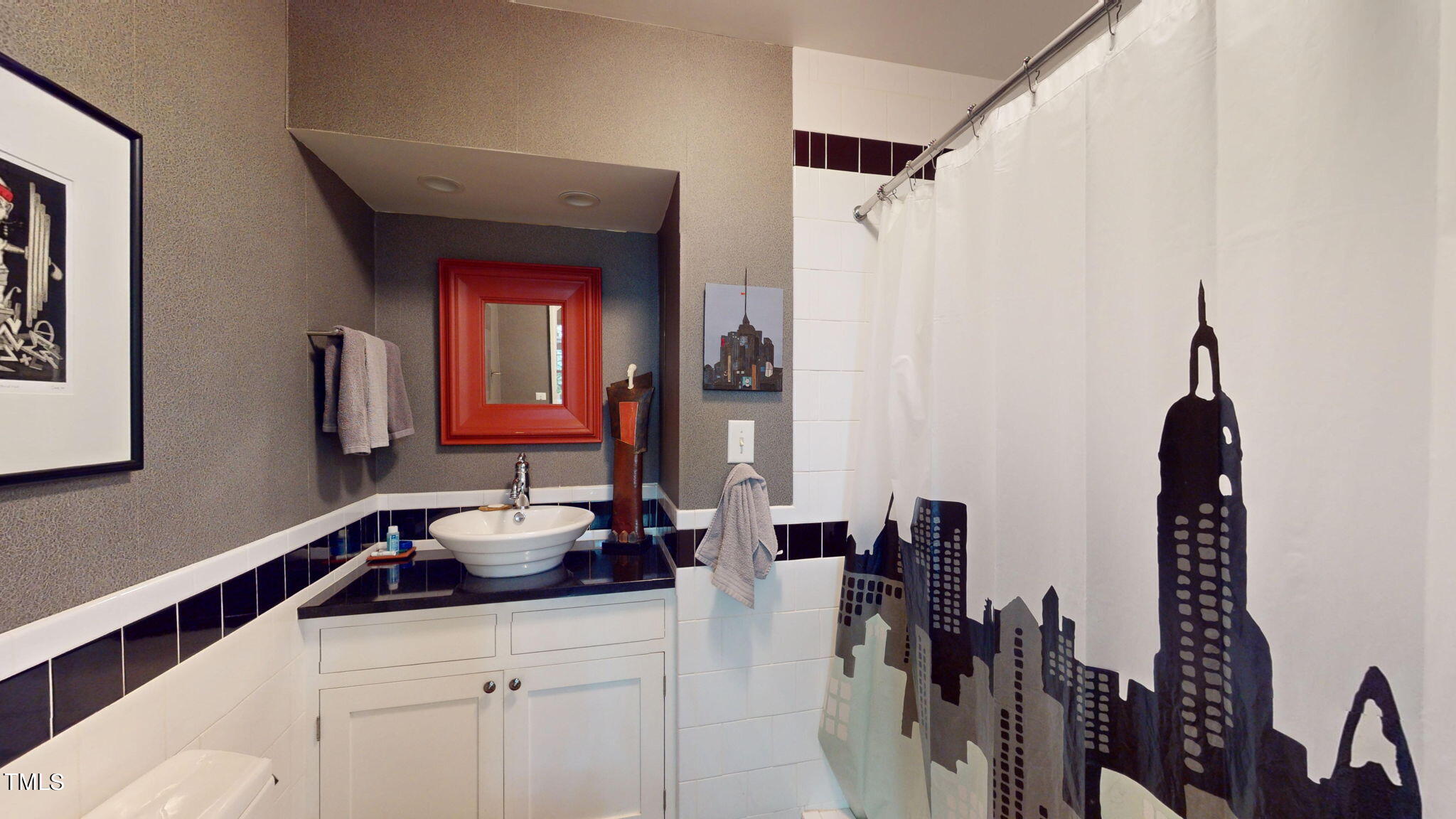 132 Woodburn Road Raleigh, NC 27605 - Photo 18 of 53 a bathroom with a sink and a mirror