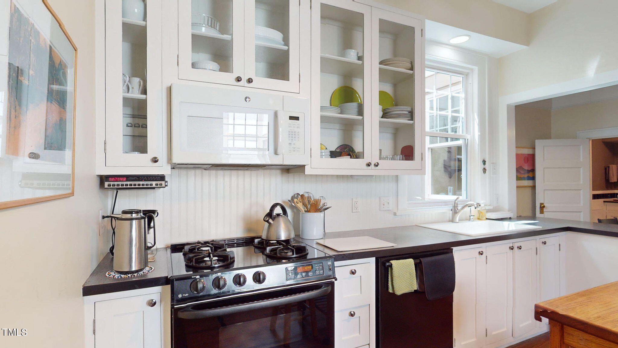 132 Woodburn Road Raleigh, NC 27605 - Photo 21 of 53 a kitchen with stainless steel appliances a stove a sink and a cabinets