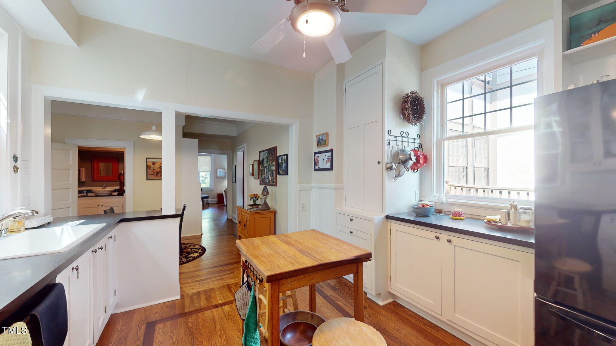 132 Woodburn Road Raleigh, NC 27605 - Photo 22 of 53 a room with a sink dishwasher a dining table and chairs with wooden floor