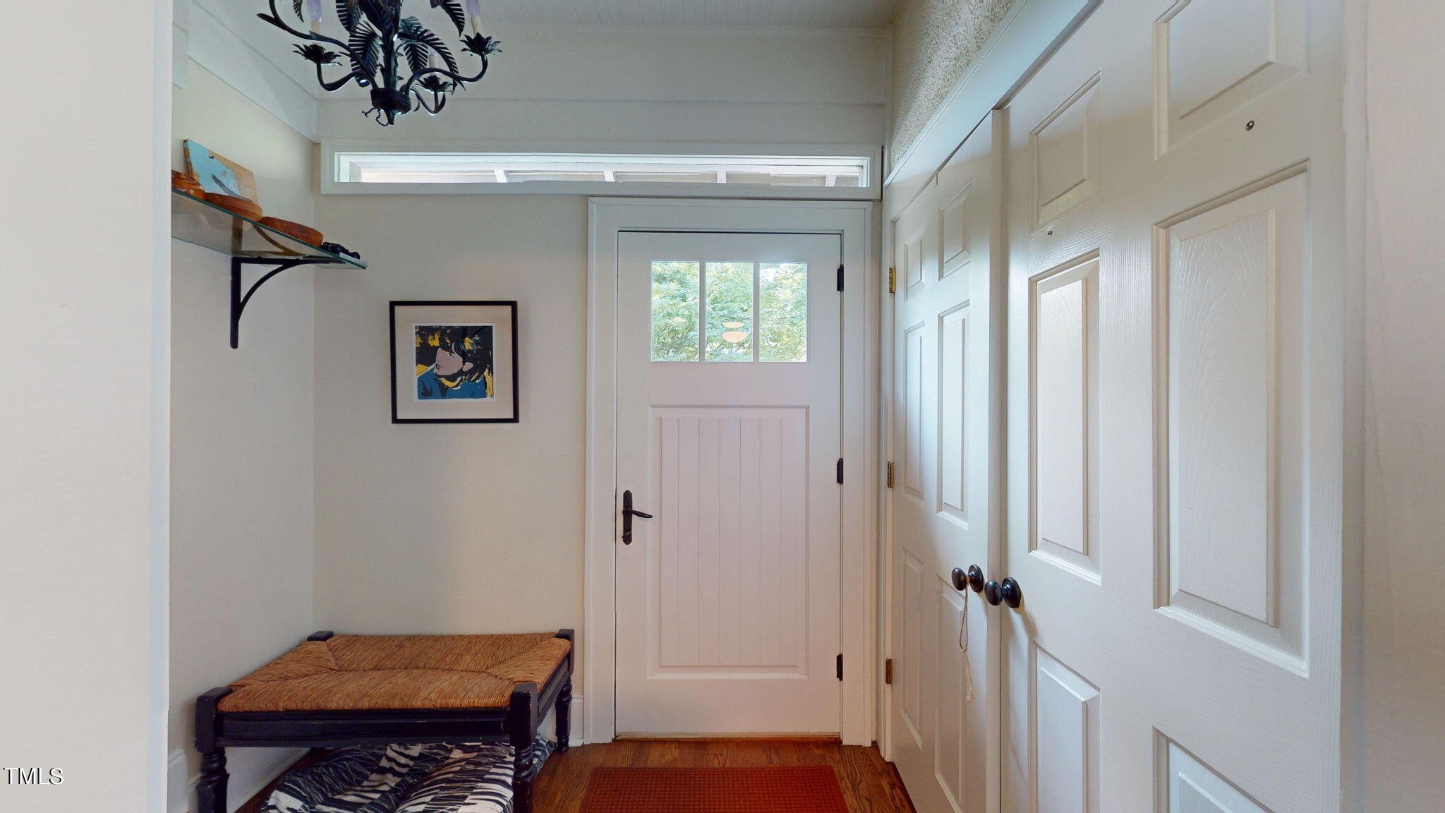 132 Woodburn Road Raleigh, NC 27605 - Photo 23 of 53 a view of a hallway with wooden floor and a livingroom