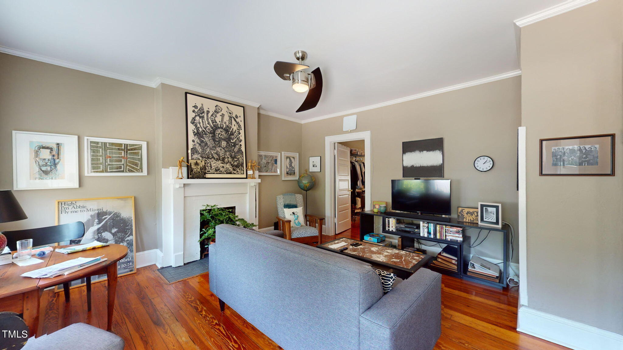 132 Woodburn Road Raleigh, NC 27605 - Photo 24 of 53 a living room with furniture a fireplace and a flat screen tv