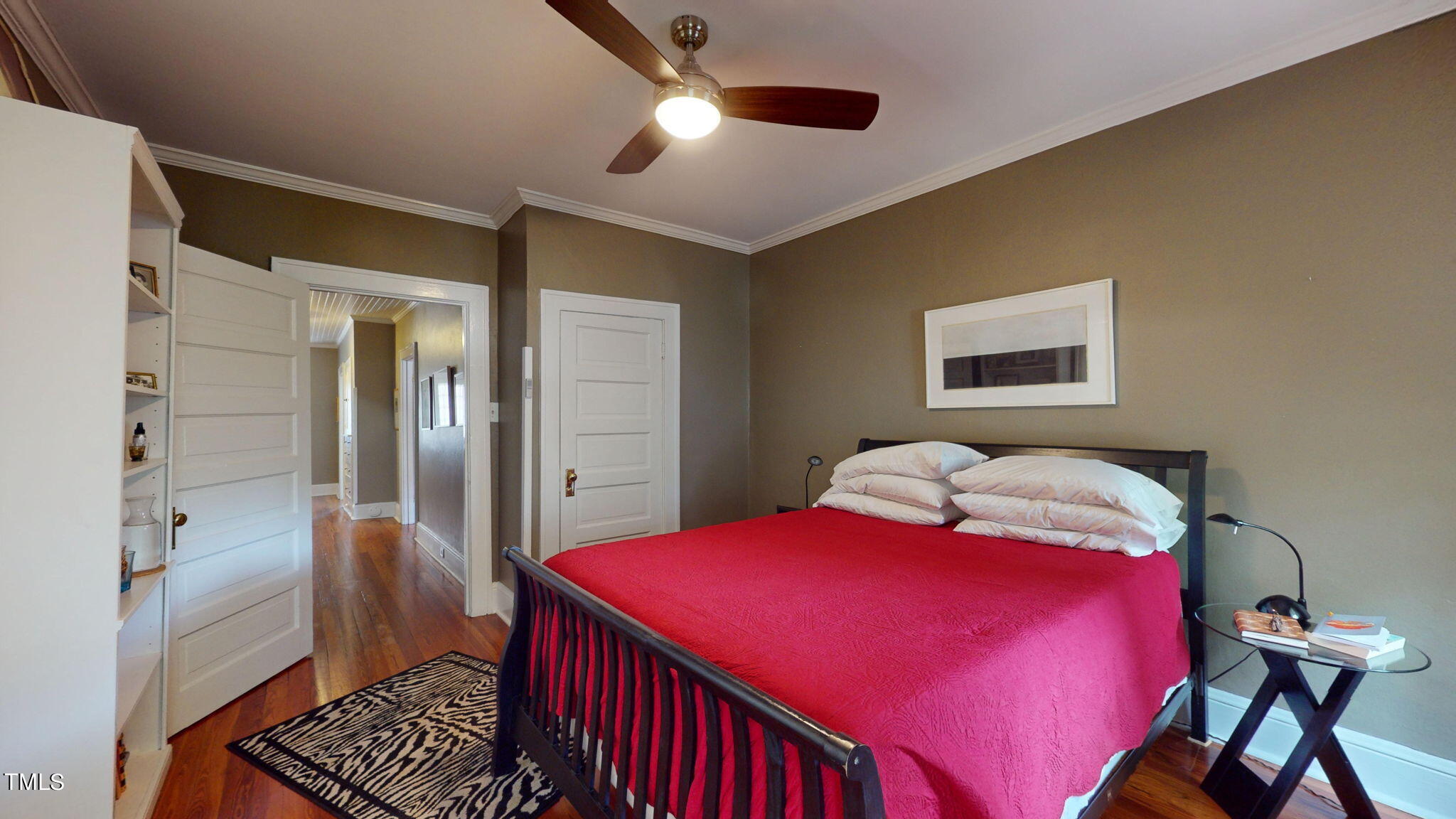 132 Woodburn Road Raleigh, NC 27605 - Photo 31 of 53 a bedroom with a bed and a chandelier