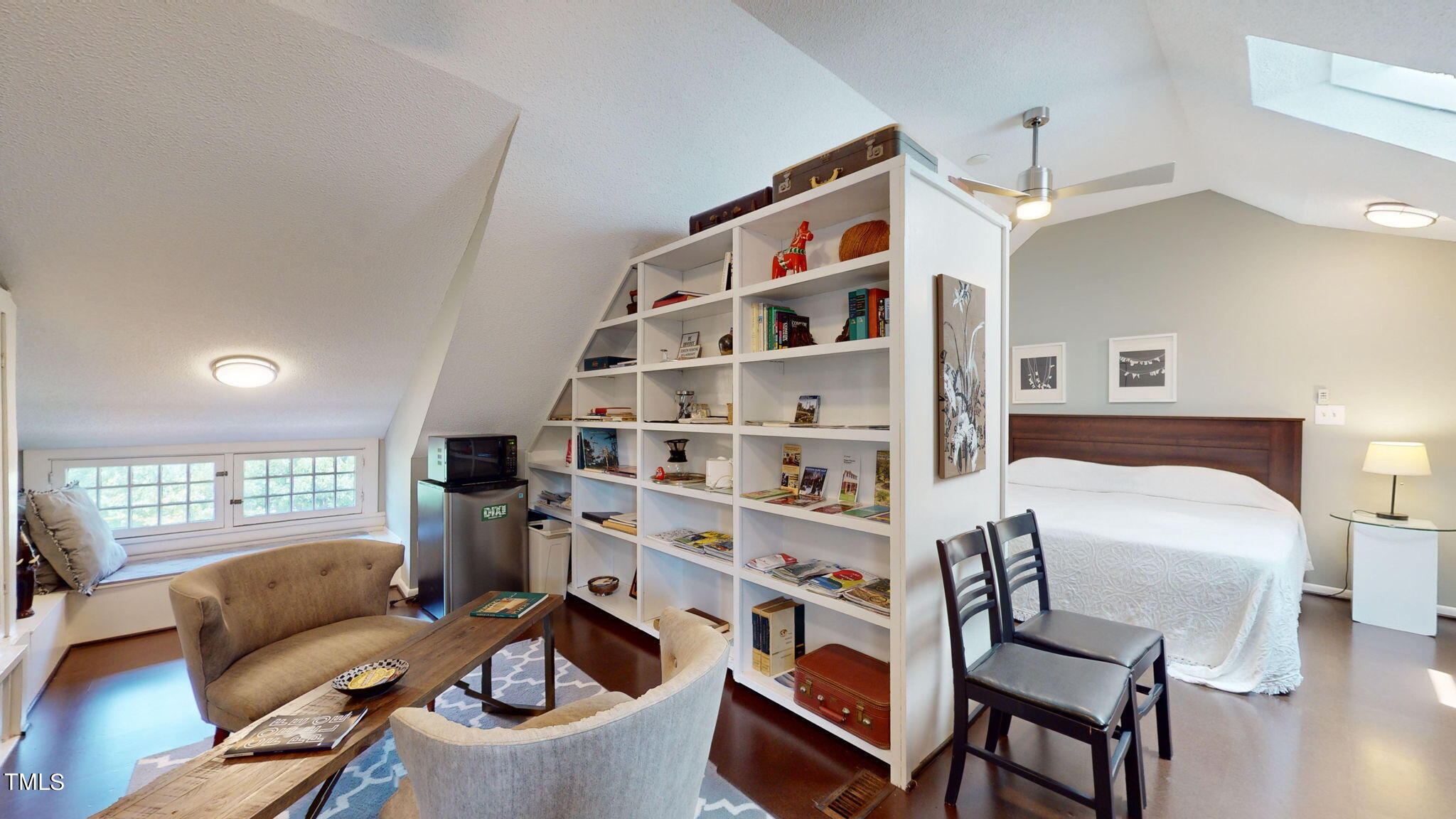 132 Woodburn Road Raleigh, NC 27605 - Photo 33 of 53 a bedroom with furniture and a book shelf