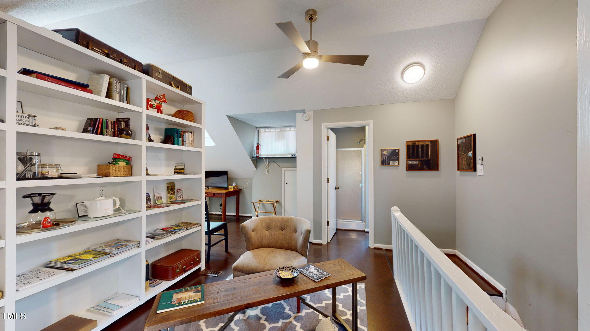 132 Woodburn Road Raleigh, NC 27605 - Photo 34 of 53 a living room with furniture and a book shelf